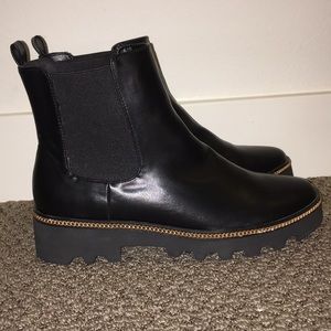Black ankle booties with gold studded chain
